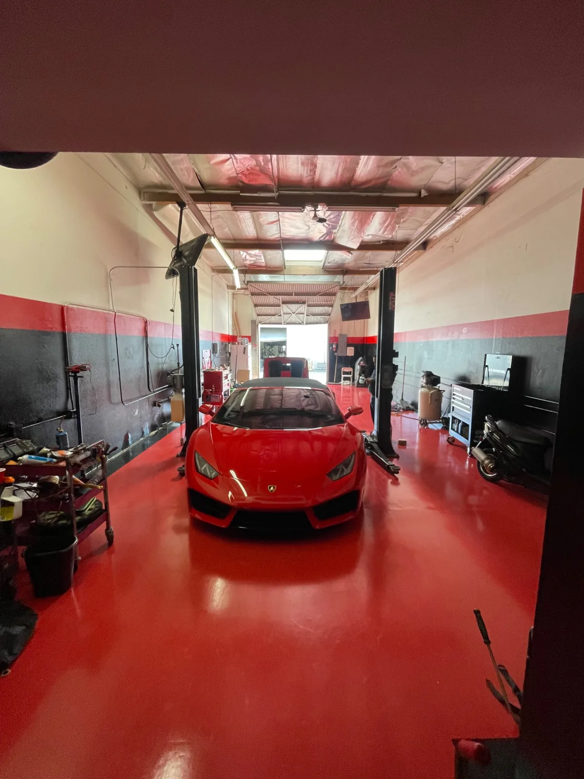 Lamborghini being serviced on a lift at Akonic Garage